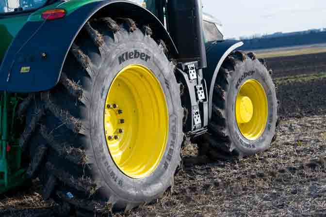 Tractor tyre on a yellow rim mounted on a green tractor
